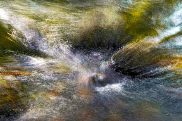 water flowing over green rocks 