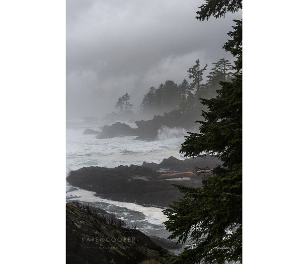 waves crashing on a beach with storm in the background