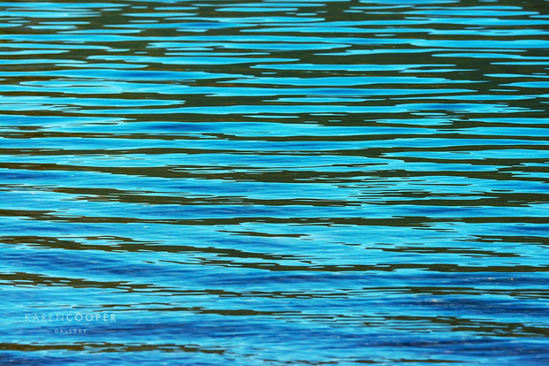 blue green ripples on surface of lake