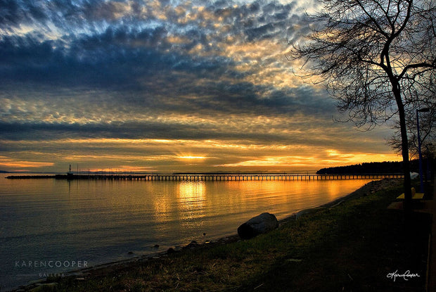 long pier with sunset in the background