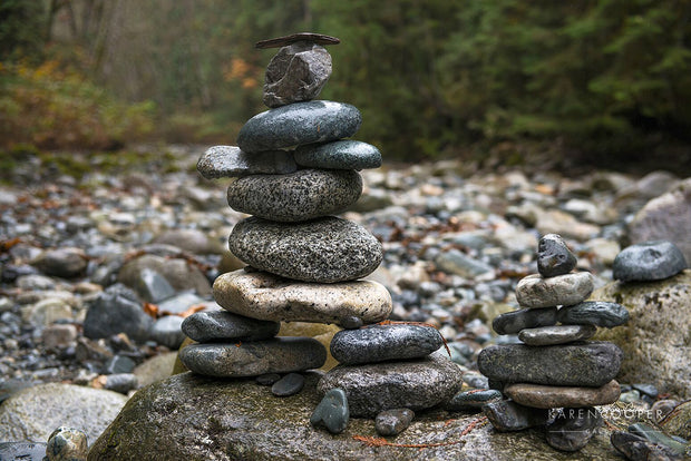 Detail of a small Inukshuk near to a small, dry riverbed. 