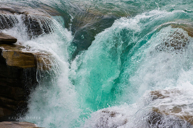 Fine art luxury nature landscape photography turquoise blue waterfall tumbling over rocks in Jasper National Park in Alberta, Canada 